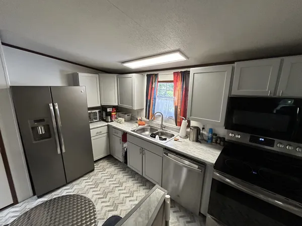 a kitchen with a sink stove and refrigerator