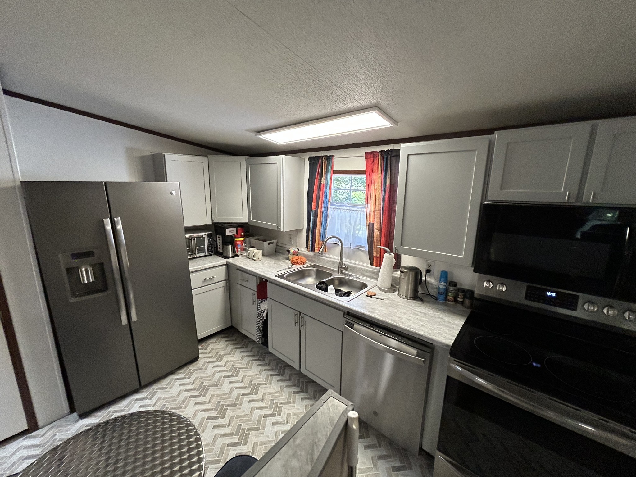 885 Sandys Camp Road Big Sandy, TN 38221 - Photo 9 of 22 a kitchen with a sink stove and refrigerator