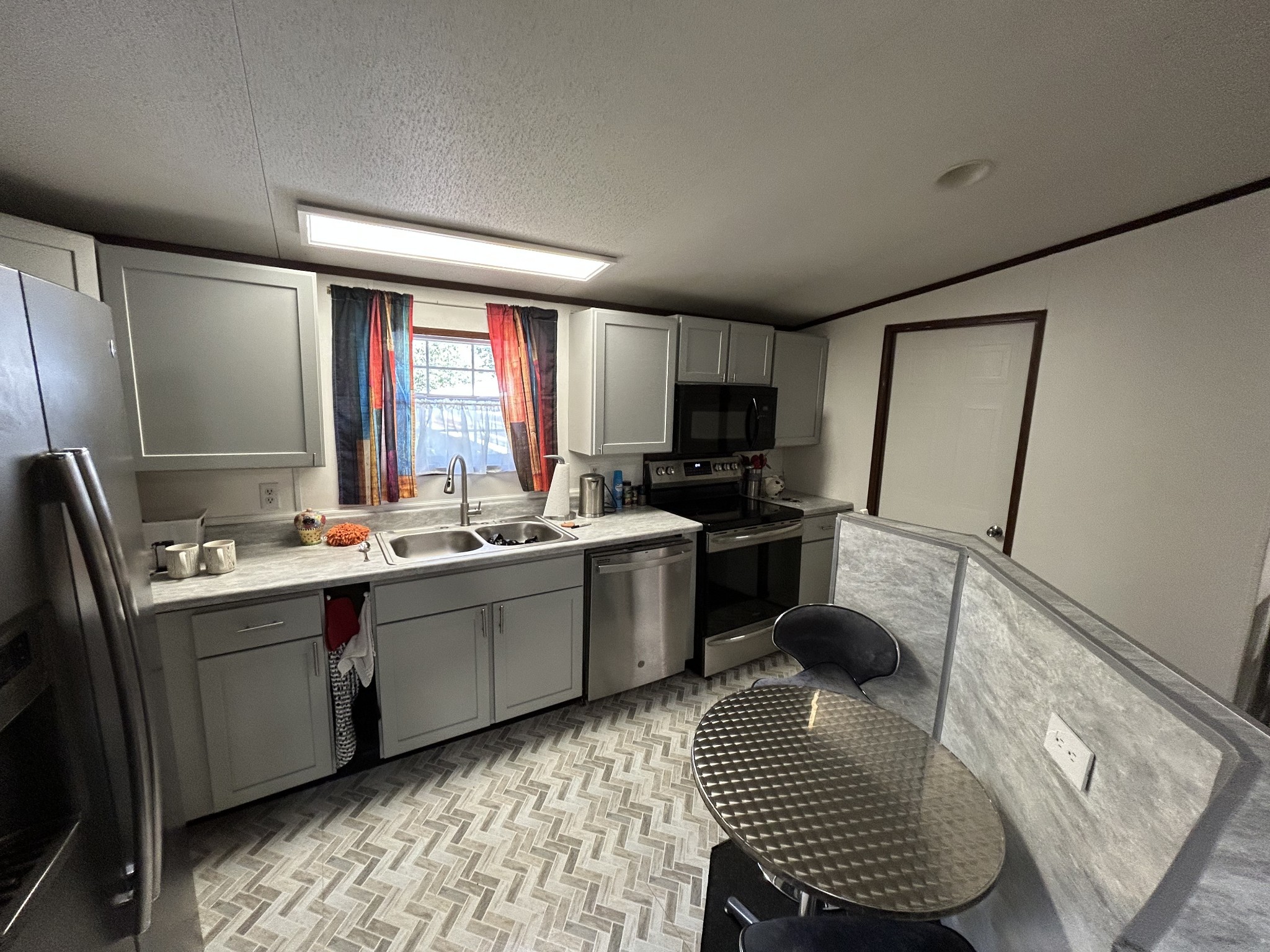 885 Sandys Camp Road Big Sandy, TN 38221 - Photo 10 of 22 a kitchen with a sink appliances cabinets and furniture