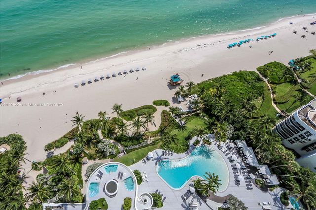 a bedroom with a large bed and a large window