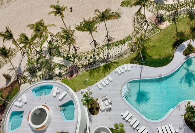 a view of a swimming pool with a yard