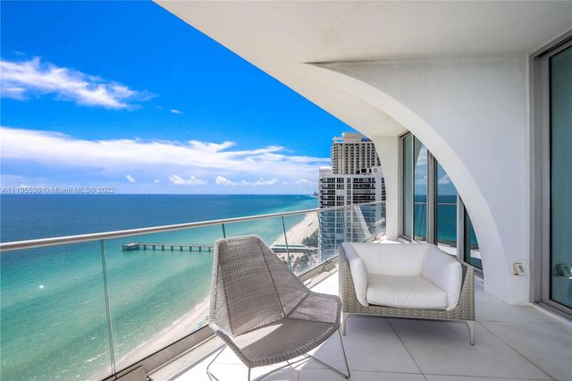 a balcony with chairs and table