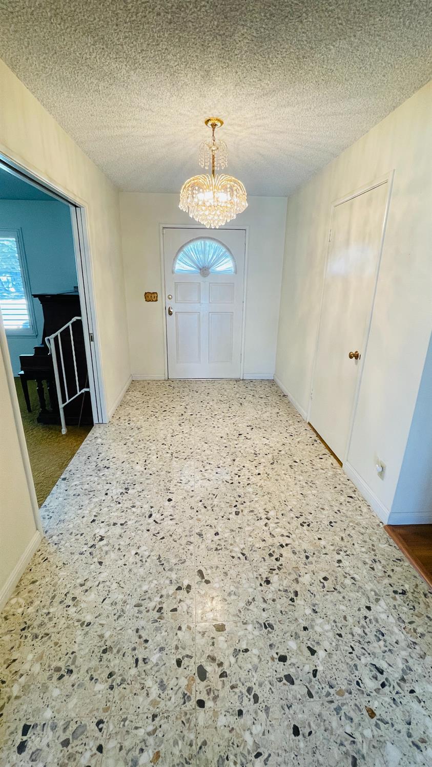 712 Leytonstone Avenue Modesto, CA 95355 - Photo 4 of 32 Large tiled entry way with gorgeous pocket doors to close off the lformal living and family rooms.
