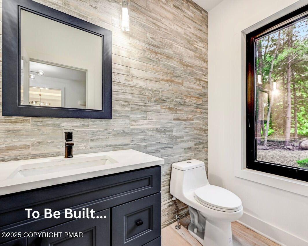 8-7 Sweet Briar Road Pocono Pines, PA 18350 - Photo 10 of 38 a bathroom with a toilet a sink and a mirror