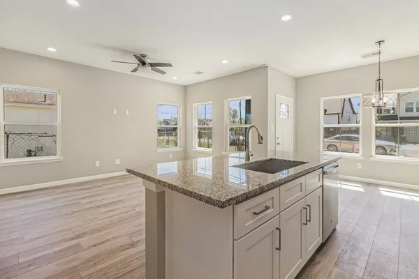 a kitchen with granite countertop counter space a sink and a window