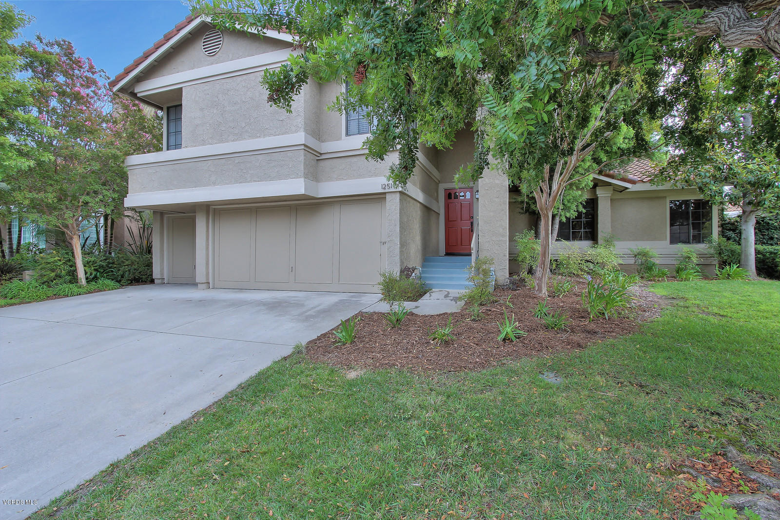 12510 Crystal Ranch Road Moorpark, CA 93021 - Photo 2 of 43 a front view of a house with a garden and trees