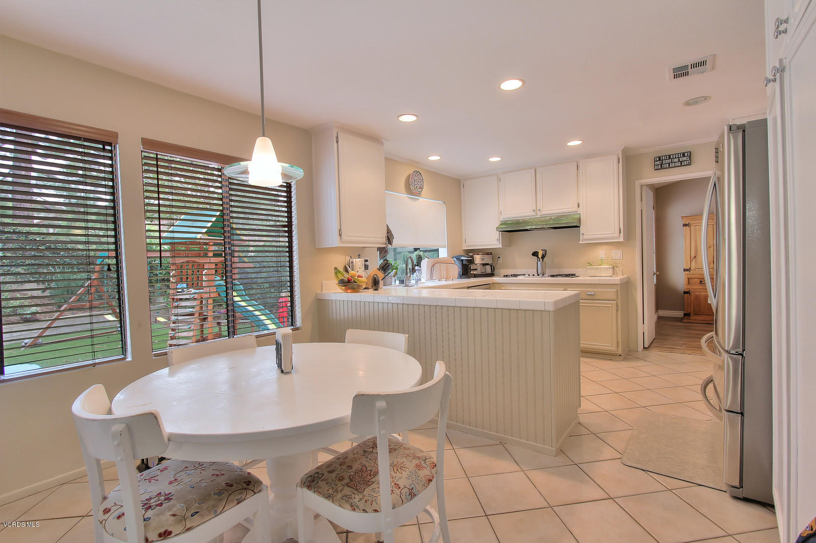 12510 Crystal Ranch Road Moorpark, CA 93021 - Photo 12 of 43 a kitchen with kitchen island a sink a stove a table and chairs