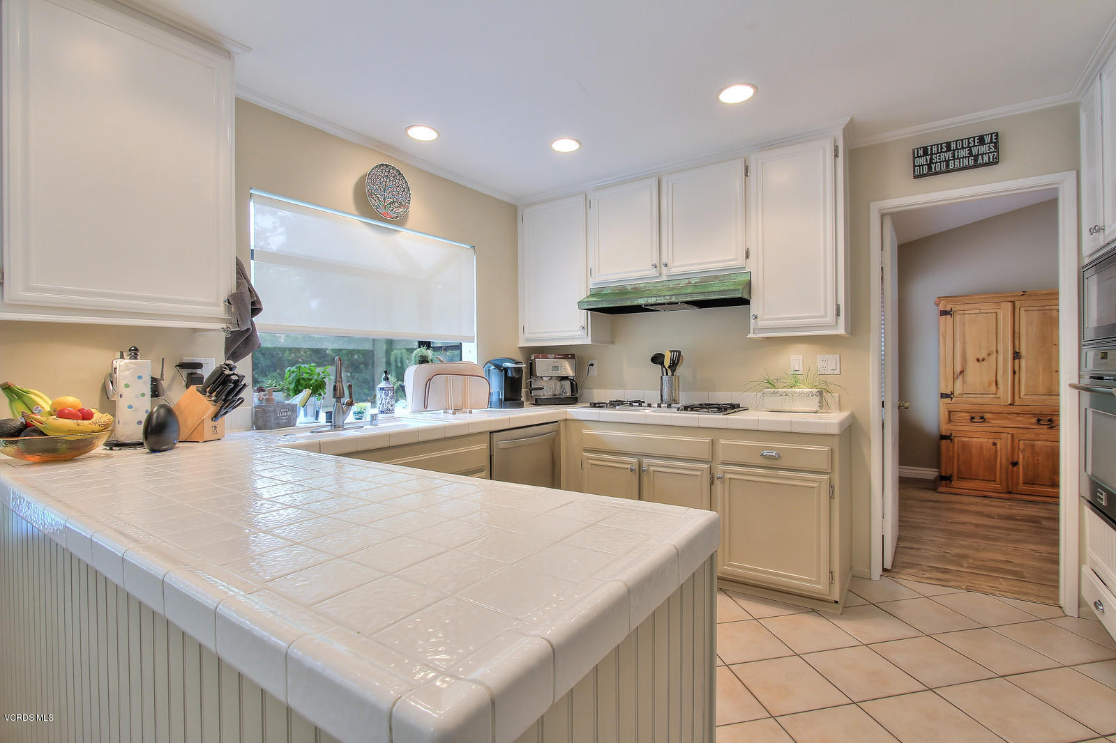 12510 Crystal Ranch Road Moorpark, CA 93021 - Photo 15 of 43 a kitchen with granite countertop a sink a stove and cabinets