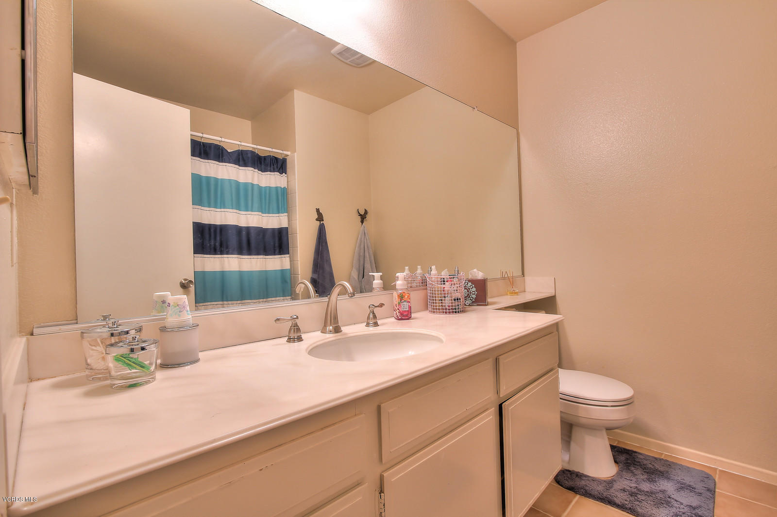 12510 Crystal Ranch Road Moorpark, CA 93021 - Photo 31 of 43 a bathroom with a granite countertop sink a toilet and a large mirror