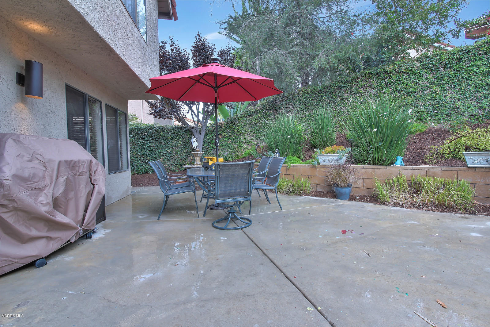 12510 Crystal Ranch Road Moorpark, CA 93021 - Photo 41 of 43 a view of a patio with a table and chairs under an umbrella