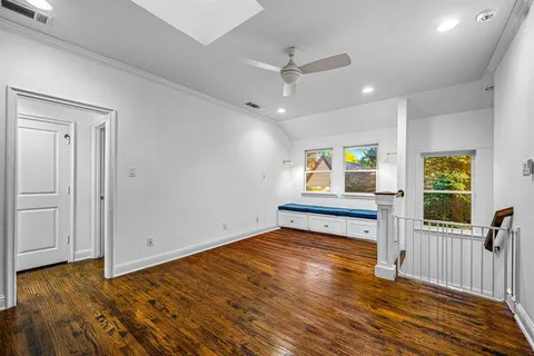 a bedroom with furniture and a wooden floor