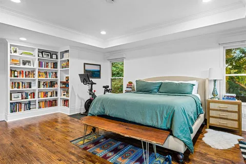 a bedroom with a bed and a flat screen tv