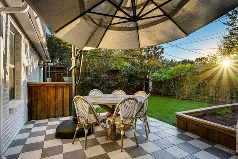 a view of a patio with table and chairs and potted plants