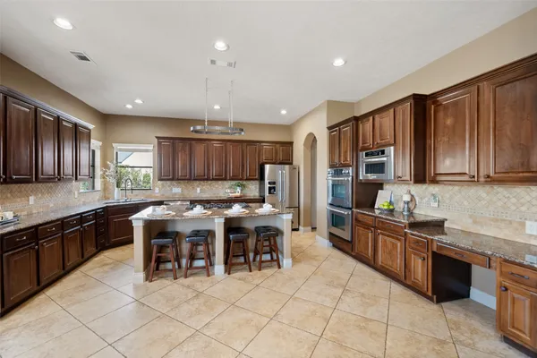 a kitchen with a stove and a refrigerator