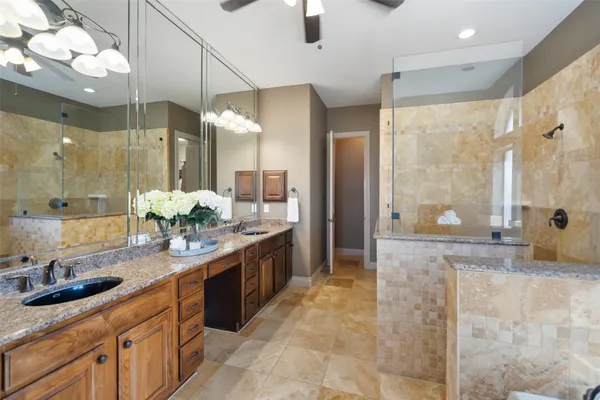 a spacious bedroom with a bed and a chandelier