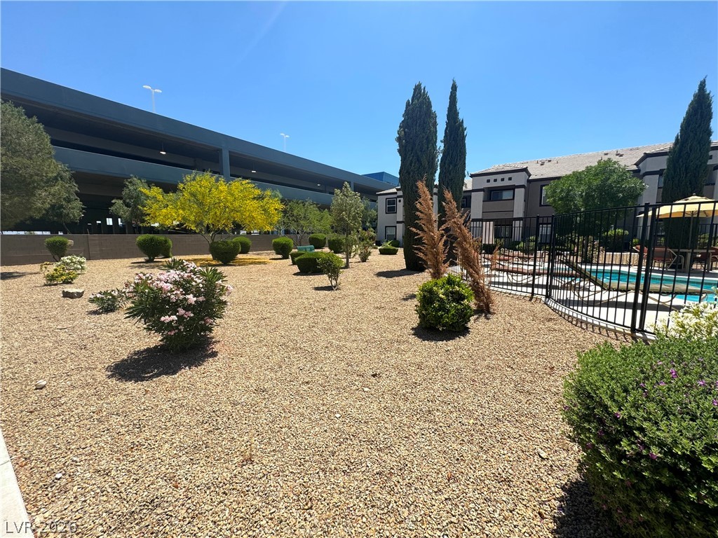 7255 West Sunset Road, Unit 2111 Las Vegas, NV 89113 - Photo 29 of 33 A well-maintained landscape featuring a pool and xeriscape design, ideal for desert living.