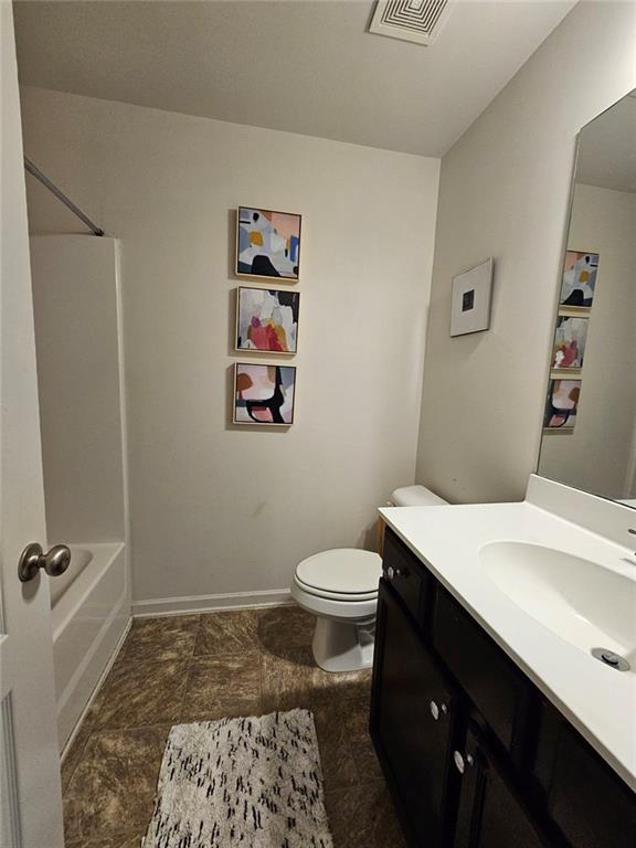 5747 Radford Loop Fairburn, GA 30213 - Photo 15 of 36 a bathroom with a sink a toilet and a shower