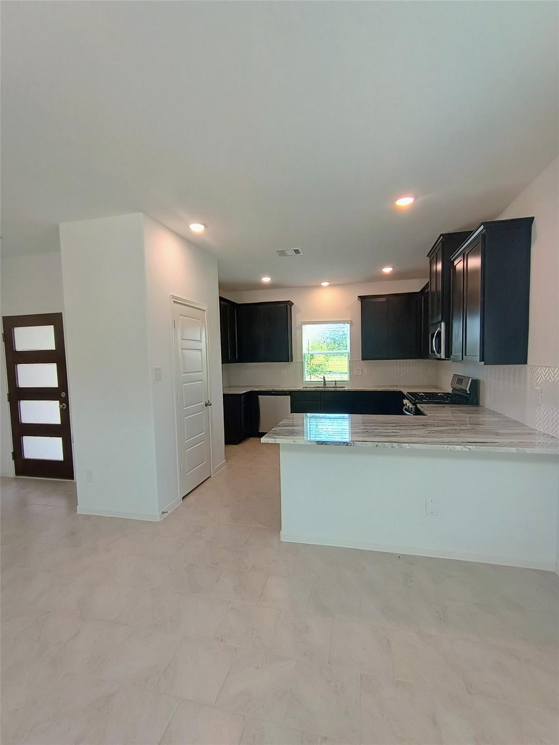 15924 Cy Young Court Splendora, TX 77372 - Photo 5 of 29 a view of kitchen with refrigerator and window