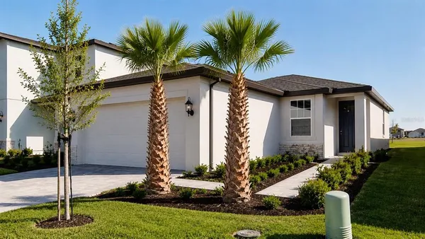 a front view of house with yard and trees