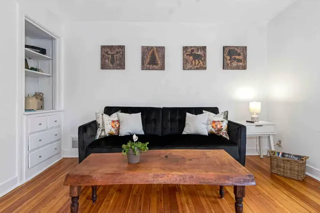 a living room with furniture and wooden floor
