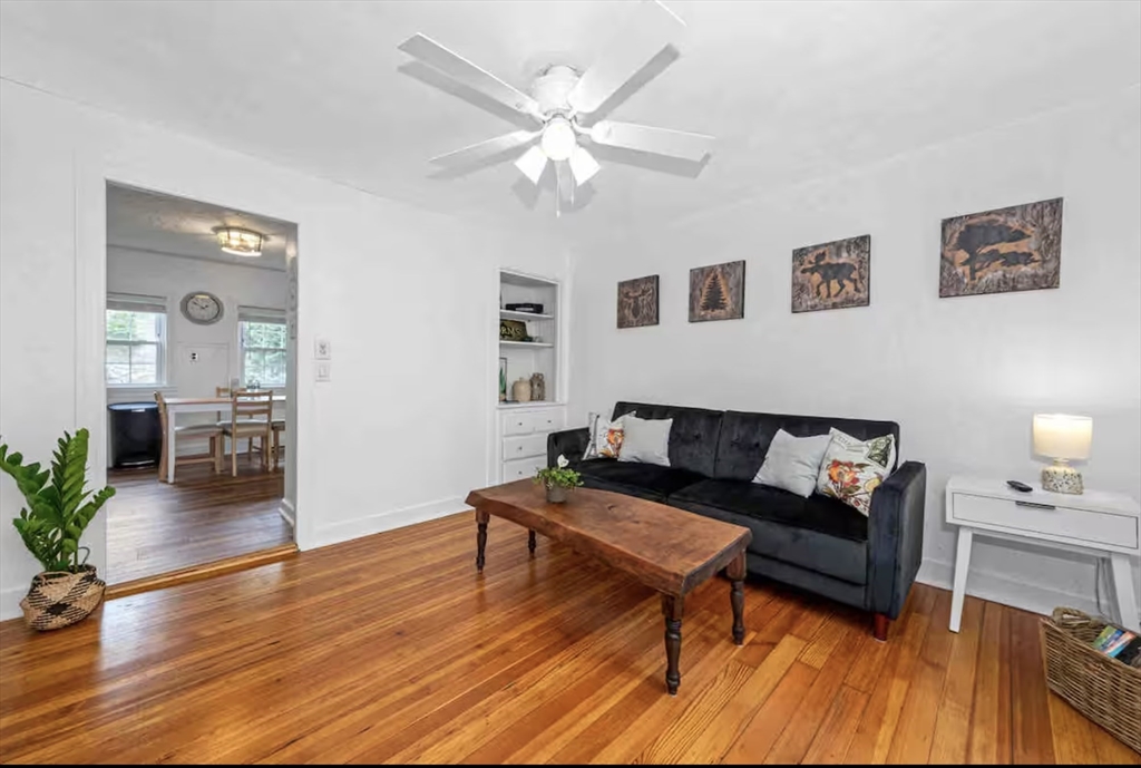 330 East Street Dedham, MA 02026 - Photo 2 of 9 a living room with furniture and wooden floor