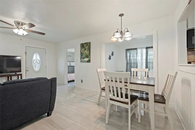 a view of a dining room with furniture and chandelier