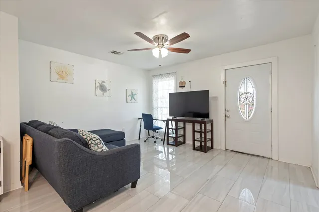 a living room with furniture and a flat screen tv