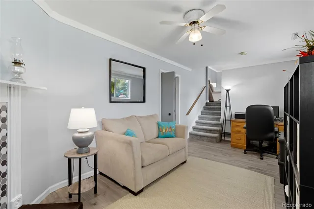 a living room with furniture and a chandelier