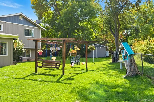 a view of house with a backyard and a slide