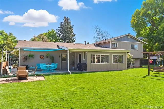 a view of a house with a yard and sitting area