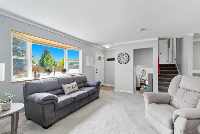 a living room with furniture and a large window