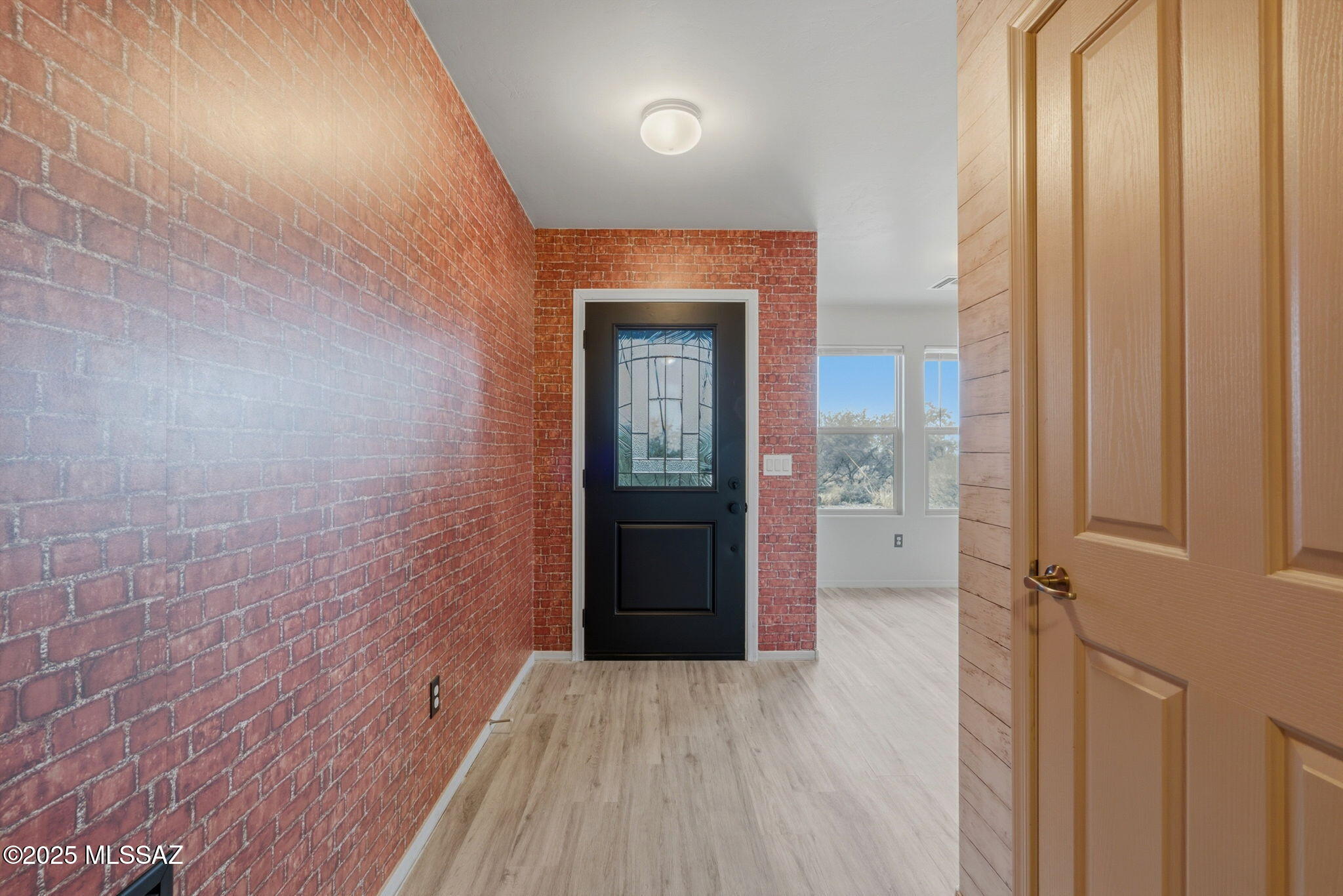 1458 North Wentworth Road Vail, AZ 85641 - Photo 8 of 44 a view of a hallway with wooden floor and a bathroom