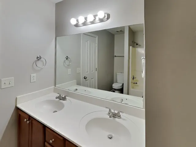 a bathroom with a sink double vanity and a mirror