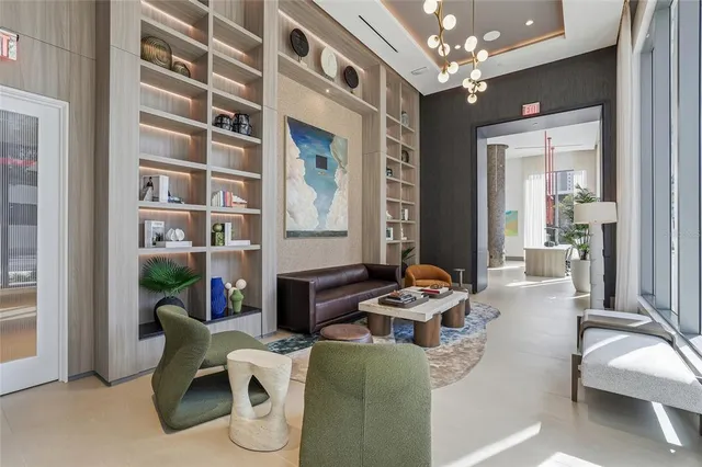 a living room with furniture a chandelier and a fireplace