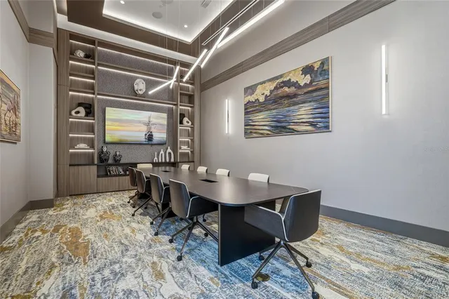 a living room with patio furniture and a chandelier