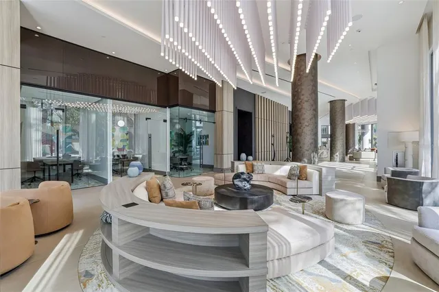 a view of a hallway with wooden floor and a bathroom