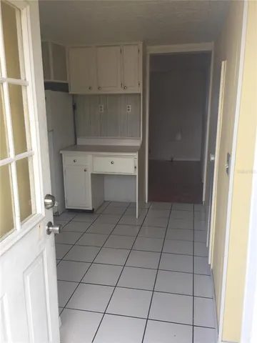 a room with a washing machine and cabinets