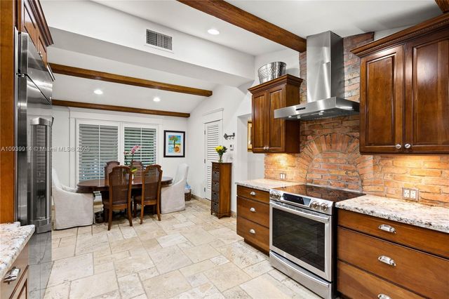 a kitchen with stainless steel appliances granite countertop a sink a microwave cabinets and a counter top space