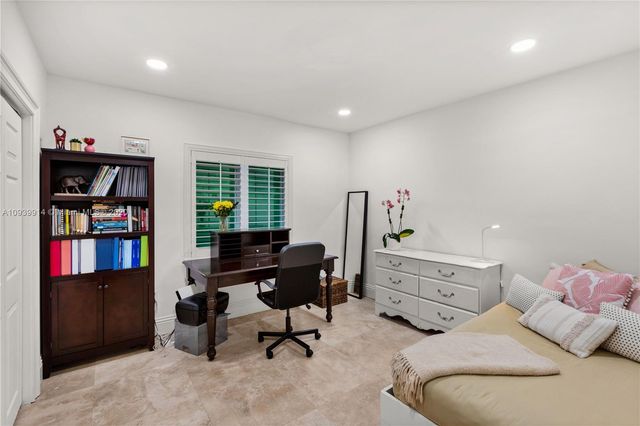 a bedroom with a bed and a desk