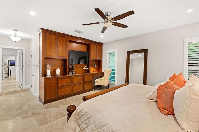 a bedroom with double bed and a dresser