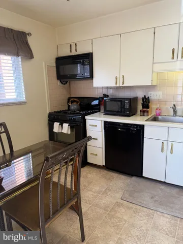 a kitchen with a stove a sink and a refrigerator