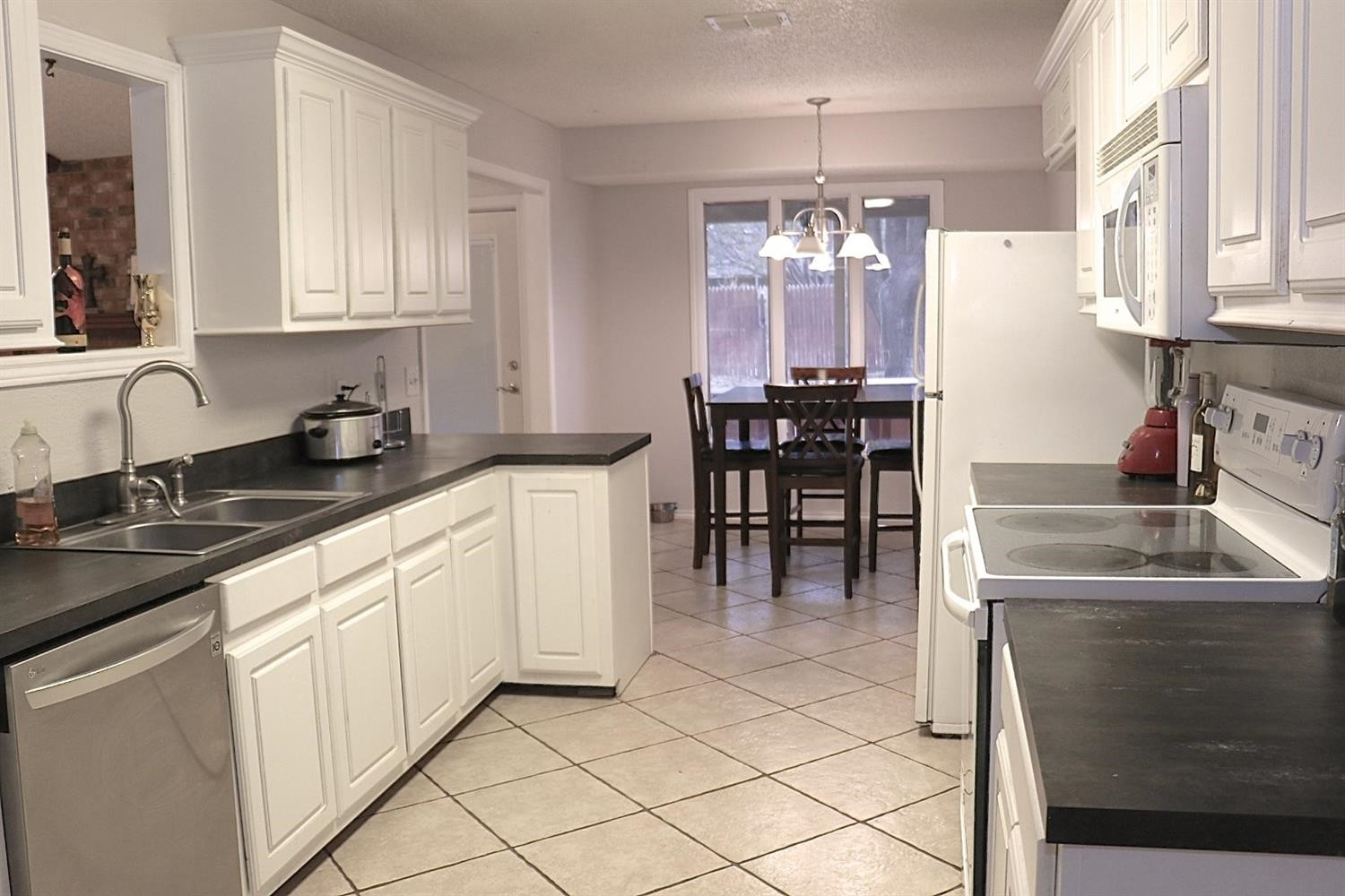 7004 Elkhart Avenue Lubbock, TX 79424 - Photo 14 of 44 a kitchen with granite countertop a sink and cabinets