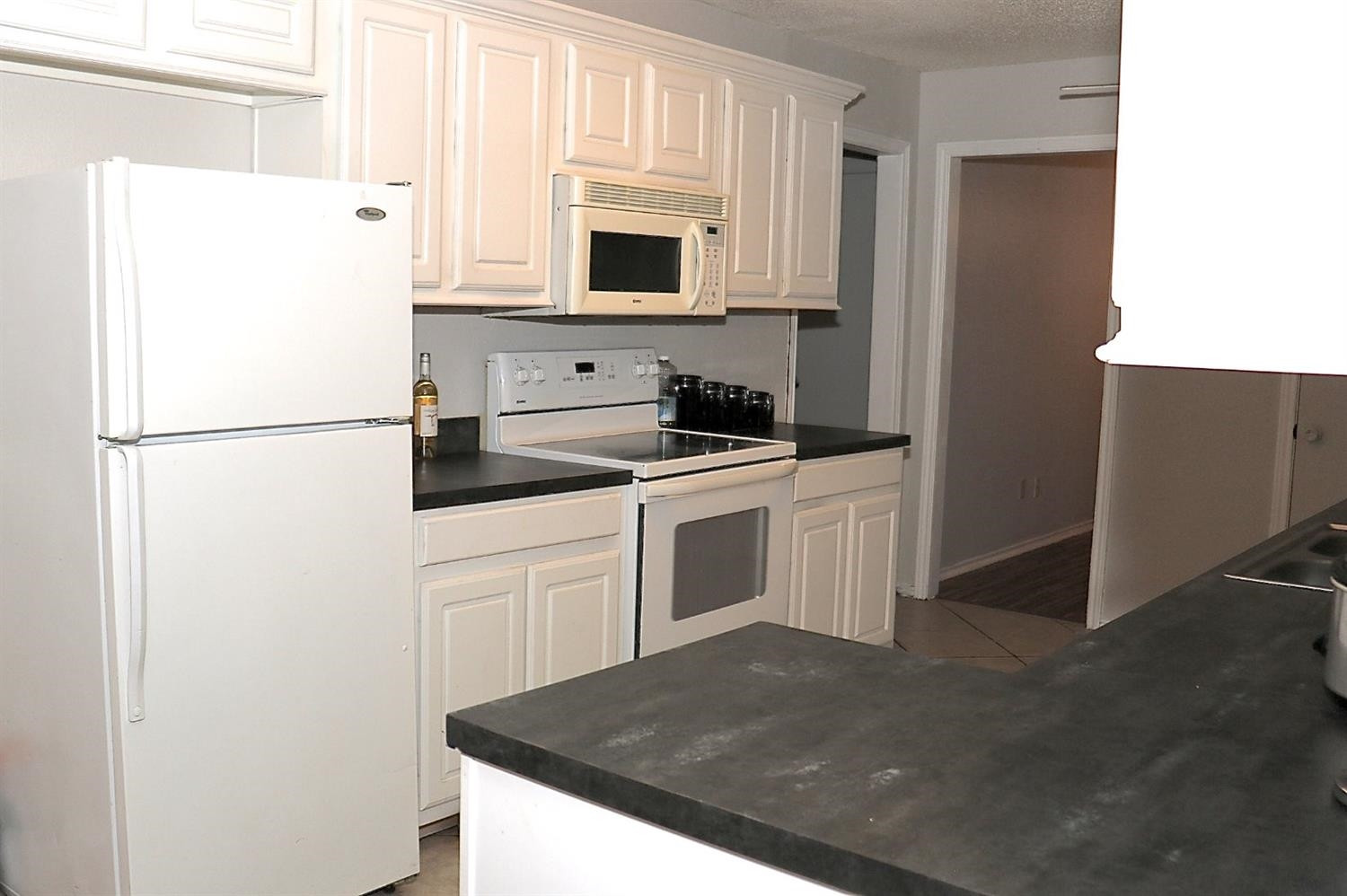 7004 Elkhart Avenue Lubbock, TX 79424 - Photo 17 of 44 a white refrigerator freezer sitting in a kitchen