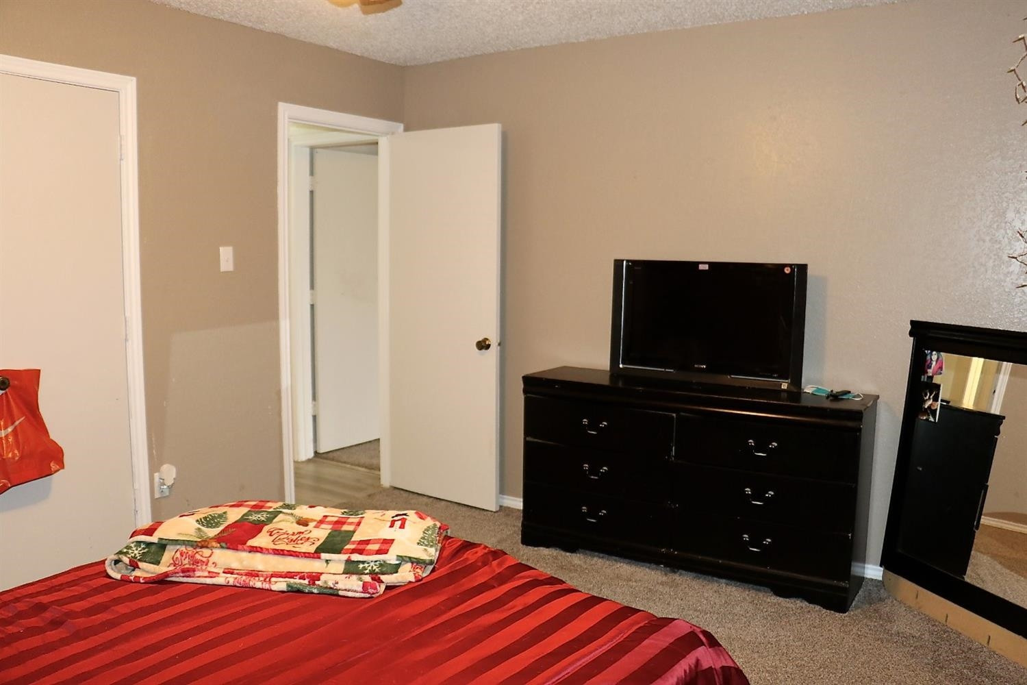 7004 Elkhart Avenue Lubbock, TX 79424 - Photo 25 of 44 a bedroom with a bed and a flat screen tv