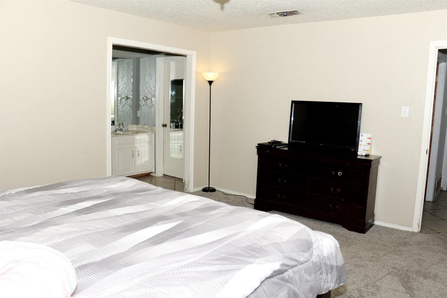7004 Elkhart Avenue Lubbock, TX 79424 - Photo 6 of 44 a bedroom with a bed and dresser