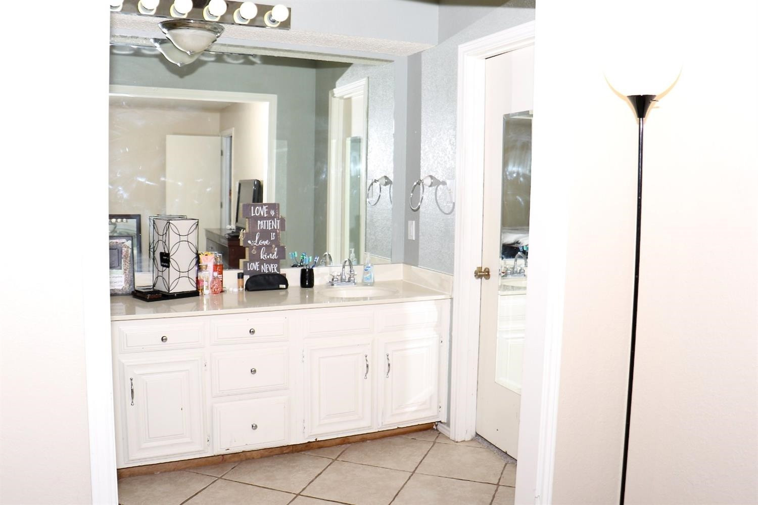 7004 Elkhart Avenue Lubbock, TX 79424 - Photo 7 of 44 a bathroom with a sink vanity and a mirror