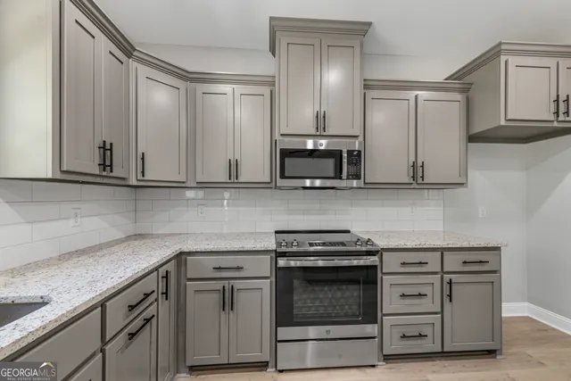 a kitchen with a sink and cabinets