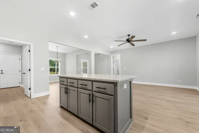 a kitchen with stainless steel appliances granite countertop a sink and cabinets