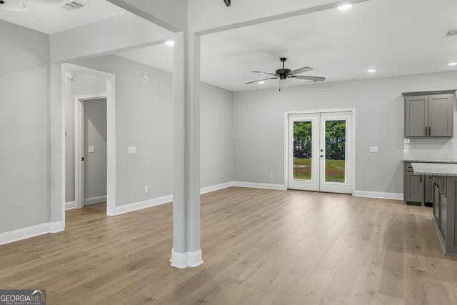 a view of kitchen with wooden floor and a window