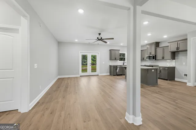 a large kitchen with stainless steel appliances granite countertop a stove a sink dishwasher a refrigerator and a view of kitchen